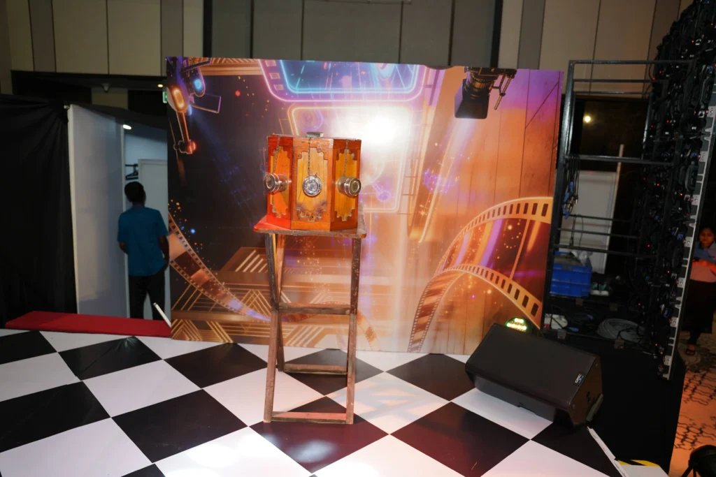 COWI Cinematic Gala 2026 photo booth with red velvet curtain backdrop, director's chair, vintage props
